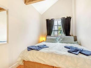 a bedroom with a bed with blue towels on it at Nightingale House in Ottery Saint Mary