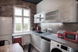 a kitchen with a stove top oven and a sink at Holidayapartments Marquardt in Berlin