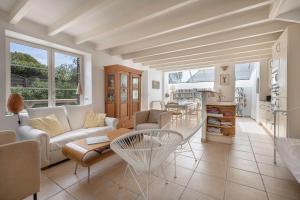 a living room with a couch and a table at Maison de caractere a 100 metres de la plage in Le Pouliguen