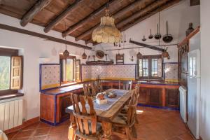 a kitchen with a table and chairs in a room at Molino de Santa Águeda in Jerez del Marquesado