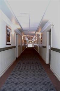 an empty hallway in a building with a long hallway at Nova Inn Inuvik in Inuvik