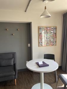 a living room with a table and a chair at Vintage Lofts in Guadalajara