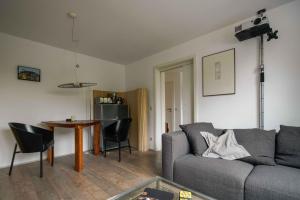 a living room with a couch and a table at Apartment Mini-Loft am Schloss in Raesfeld