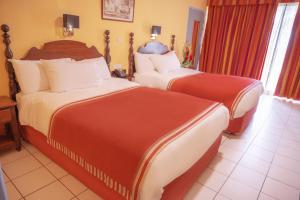 Ein Bett oder Betten in einem Zimmer der Unterkunft Hotel Bakoua Martinique