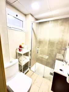 a bathroom with a shower and a toilet and a sink at Apartamento Marysol in Benalmádena