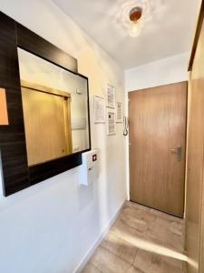 a hallway with a door and a television on the wall at Apartamento Marysol in Benalmádena