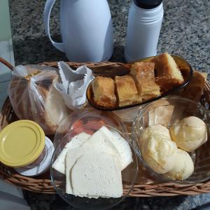 a basket of bread and other foods on a table at Portal da alvorada in Praia Grande +19 photos