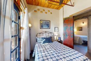 a bedroom with a bed in a room with a window at Casa de Taos in Arroyo Hondo