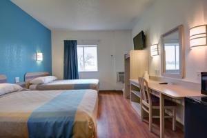 a hotel room with two beds and a desk at Motel 6-Denison, TX in Denison +37 photos