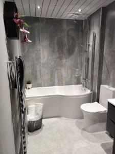 a bathroom with a tub and a toilet and a sink at The Ribchester Arms in Blackburn