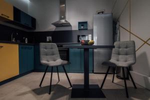 a kitchen with two chairs and a table in it at La Casa 2 in Vršac +12 photos