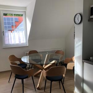 a dining room with a glass table and chairs at Ferienwohnung am Eggegebirge in Bad Driburg