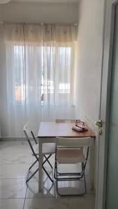 a table and two chairs in a room at Atmosfera B&B al centro della città in Cosenza