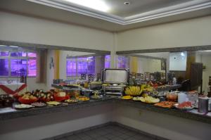 a buffet line with many different types of food at Hotel Vivo in Garanhuns