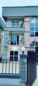 a building with a fence in front of it at Boujee Residence Apartment in Kampala