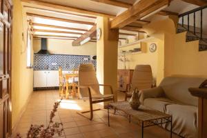 a living room with a couch and a table at MAS DE BONDIA - Casa Herrero in Alpuente