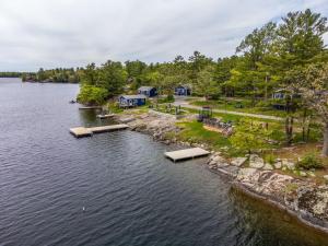 an aerial view of a lake with houses and trees at The Trace at Oak Lake (19+) in Havelock