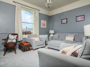 a living room with a couch and chairs and a window at Ferrystone in Dartmouth