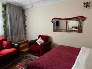 a bedroom with a red bed and a red couch at Ada Hotel Istanbul in Istanbul