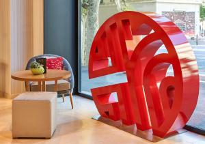 a large red sculpture in a room with a table at NH Collection Marseille in Marseille