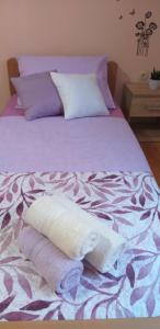 a bed with two towels on top of it at Apartman Blazenka in Viskovo