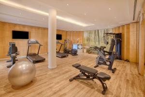 a gym with several exercise equipment in a room at NH Lecco Pontevecchio in Lecco