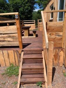 a wooden deck with a picnic table on it at Postwood Gardens Balmoral Country Cabin in Kentisbeare