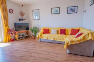 a living room with a couch and a television at Cozy apartments with sea view in Novi Vinodolski +19 photos