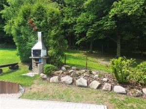 a garden with rocks and a grill in a yard at Pension U Štěpánků in Trpišovice