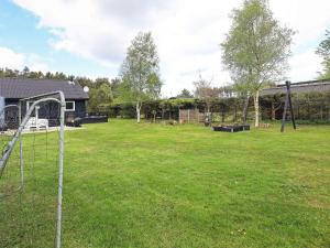 a yard with a goal in the grass at 6 person holiday home in Hals in Hals