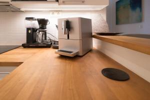 a coffee machine sitting on a counter in a kitchen at Luxury Design Gem in City Center with Sauna and workspace in Helsinki +27 photos