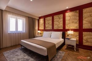 a bedroom with a large bed and a window at El Doris Boutique Living in Marsaskala