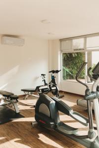 a gym with three exercise bikes and a window at Hotel Suites Villasol in Puerto Escondido
