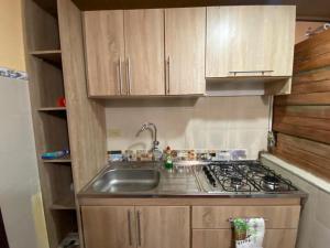 a small kitchen with a sink and a stove at Apartamento En Pueblito Boyacense in Duitama +3 photos