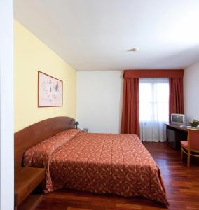 Voodi või voodid majutusasutuse Hotel La Cascata toas