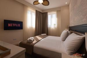 a bedroom with a bed with towels on it at El Doris Boutique Living in Marsaskala +29 photos