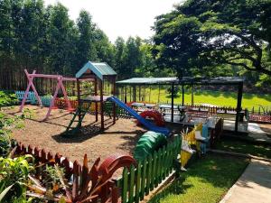 a playground with a slide and a swing set at Cheese Farm & Lodge in Mtubatuba
