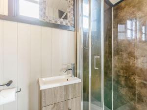 a bathroom with a sink and a glass shower at Daisys Rest in Shipton under Wychwood