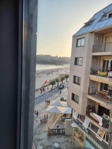 a view of a beach from a window of a building at Loft silgar in Sanxenxo