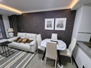 a living room with a couch and a table at Loft silgar in Sanxenxo