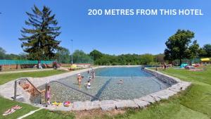 a group of people in a pool at a park at Hotel Frýdl in Prague