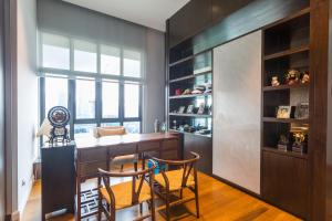 a kitchen with a bar with two chairs and a window at KLCC Luxury Condo Damai 88 Near Gleneagles Hospital in Kuala Lumpur