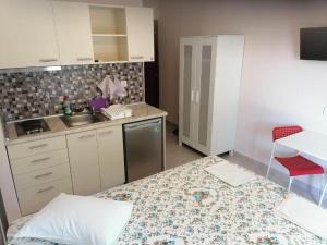a small kitchen with a sink and a counter top at KALIPSO STUDIOS in Nikiti