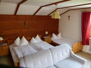 a living room with two beds and a couch at Fernblick Frühstückspension in Schoppernau