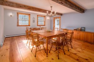 a dining room with a wooden table and chairs at Colonial Home Directly on Kingdom Trails! in East Burke