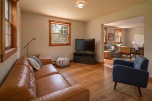 a living room with a couch and a television at Colonial Home Directly on Kingdom Trails! in East Burke