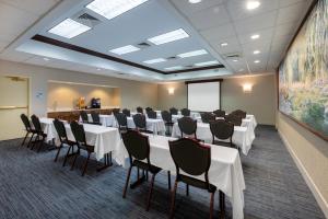 a conference room with tables and chairs and a whiteboard at Holiday Inn Express State College at Williamsburg Square, an IHG Hotel in State College