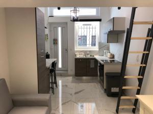 a small kitchen with a sink and a stove at L Ancien Canut Cosy in Lyon +3 photos