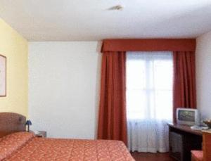Voodi või voodid majutusasutuse Hotel La Cascata toas