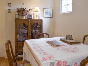 a dining room with a table with a white table cloth at The Wee Hoose in Kinghorn